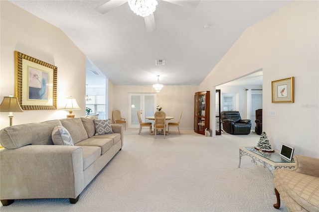 carpeted living room featuring a textured ceiling, vaulted ceiling, and ceiling fan