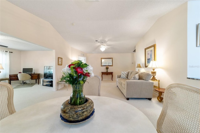 living room featuring light carpet, ceiling fan, and lofted ceiling