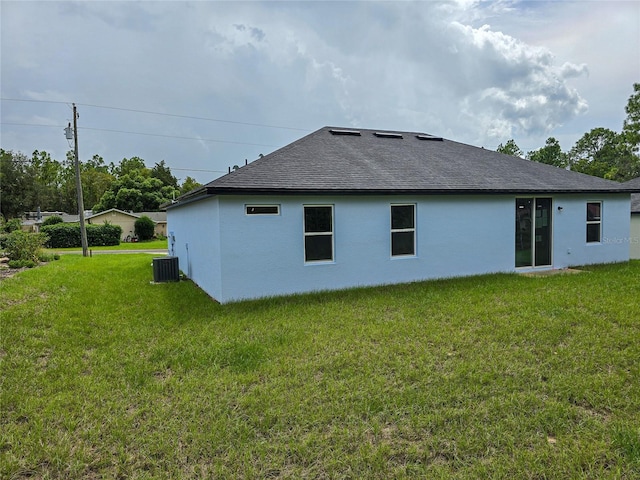 rear view of property featuring a yard