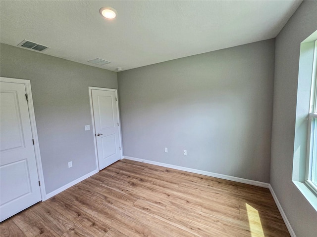 spare room featuring light wood-type flooring