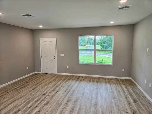 unfurnished room with light wood-type flooring