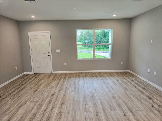 empty room with light hardwood / wood-style floors