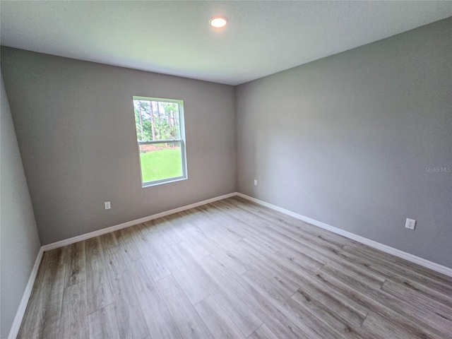 spare room with light wood-type flooring