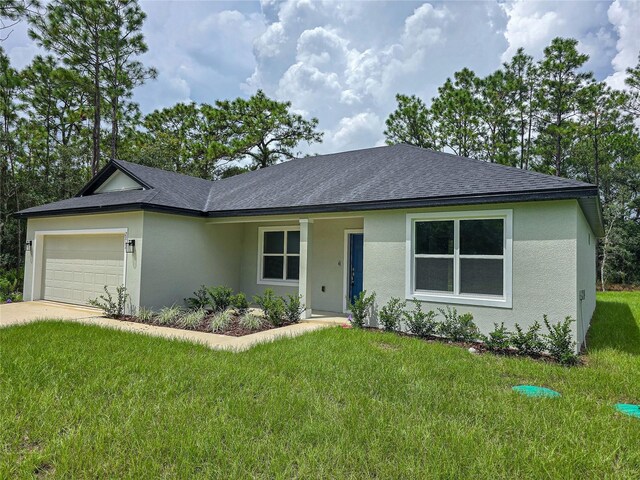 ranch-style home featuring a garage and a front lawn