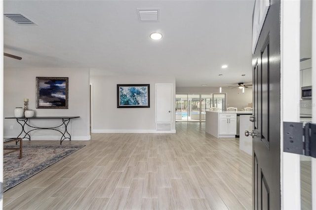 living room featuring ceiling fan and light hardwood / wood-style floors