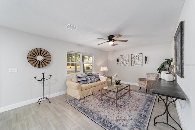 living room featuring ceiling fan and light hardwood / wood-style flooring