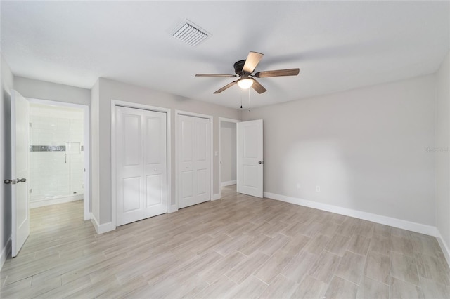 unfurnished bedroom with ceiling fan, multiple closets, and light hardwood / wood-style flooring