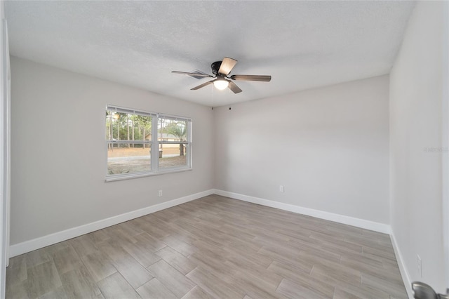 spare room featuring a textured ceiling, light hardwood / wood-style flooring, and ceiling fan