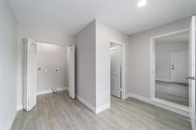 unfurnished bedroom featuring a closet and light hardwood / wood-style flooring