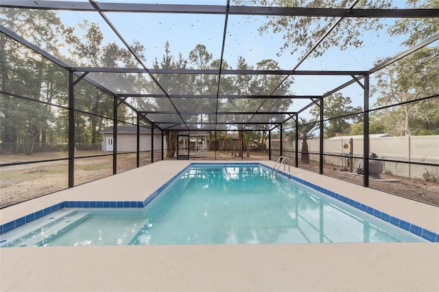 view of pool with glass enclosure and a patio area