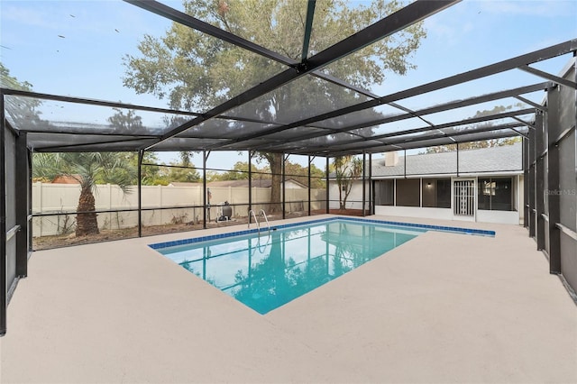 view of pool with a sunroom, a patio area, and a lanai