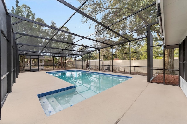 view of swimming pool with a patio area and glass enclosure