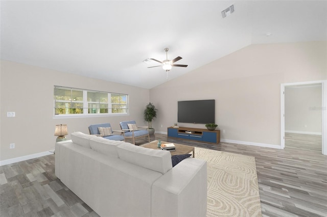 living room featuring ceiling fan, wood-type flooring, and vaulted ceiling