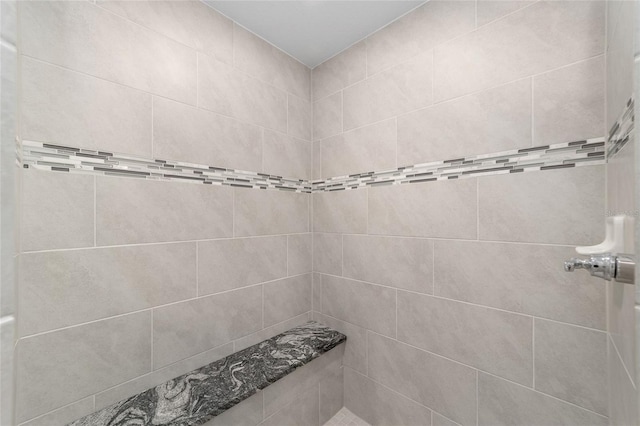 bathroom with tiled shower