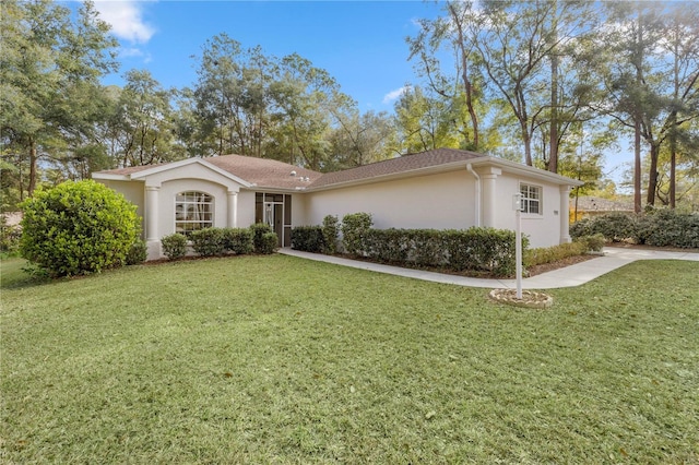 single story home with a front lawn and stucco siding