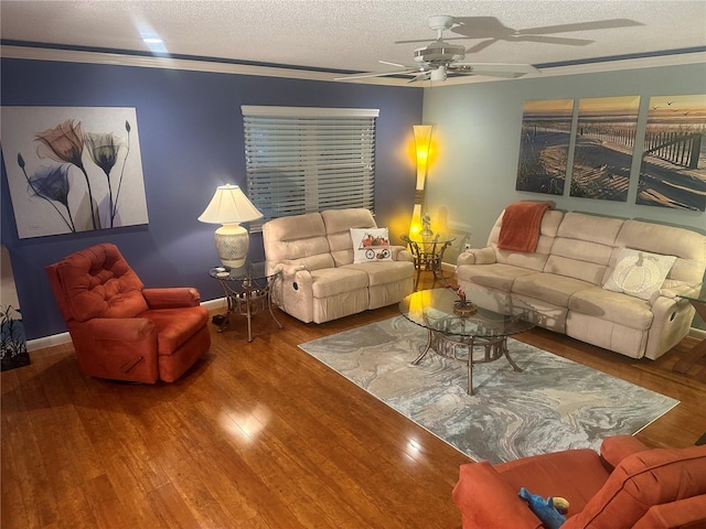 living room featuring a textured ceiling, hardwood / wood-style flooring, ceiling fan, and ornamental molding