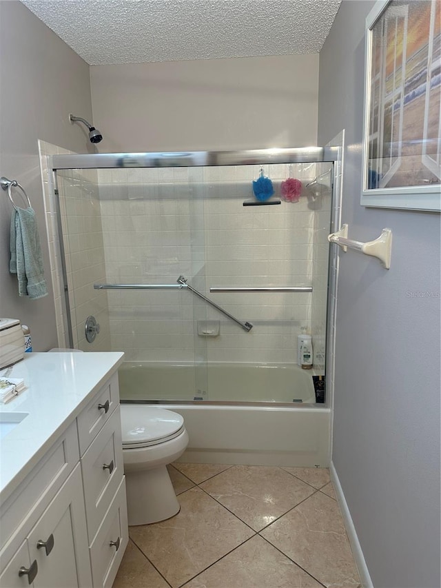 full bathroom with tile patterned flooring, vanity, a textured ceiling, and bath / shower combo with glass door