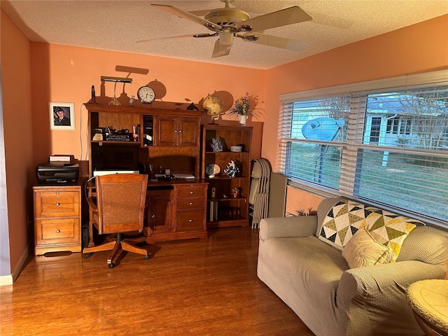 office space with dark hardwood / wood-style floors, ceiling fan, and a textured ceiling