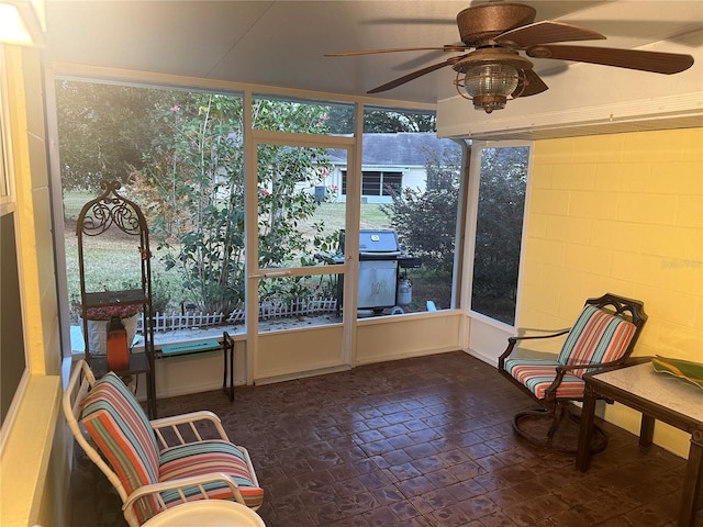 sunroom featuring ceiling fan