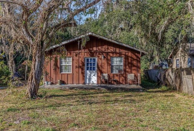 view of outbuilding featuring a lawn