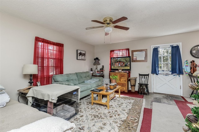 living room with ceiling fan, concrete floors, and a textured ceiling