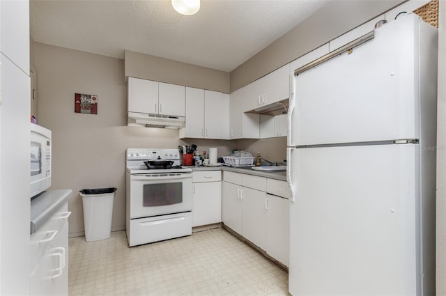 kitchen with a textured ceiling, white appliances, white cabinetry, and sink