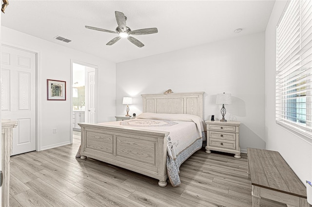 bedroom with connected bathroom, light hardwood / wood-style floors, and ceiling fan