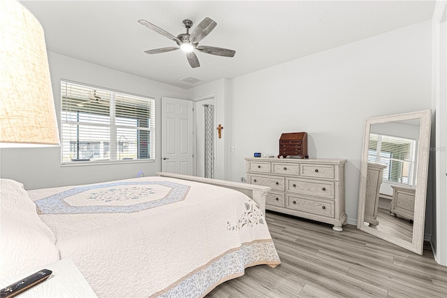 bedroom with ceiling fan and light wood-type flooring