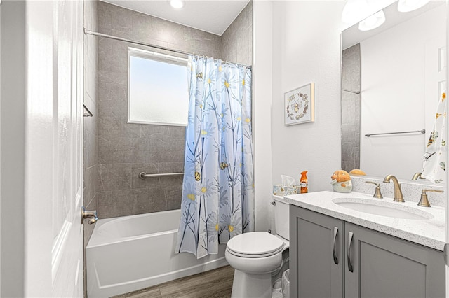 full bathroom featuring hardwood / wood-style flooring, vanity, toilet, and shower / tub combo with curtain