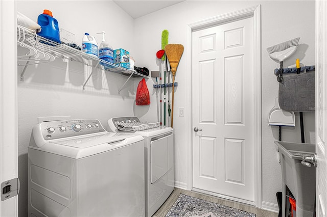 washroom featuring washing machine and clothes dryer and hardwood / wood-style floors