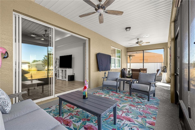 sunroom featuring ceiling fan and wood ceiling