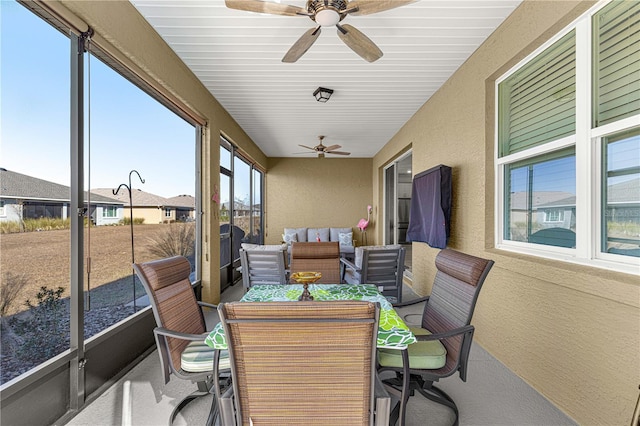 sunroom featuring ceiling fan