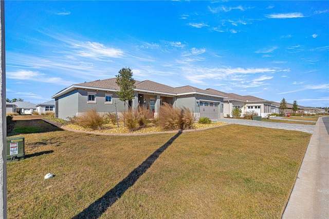 ranch-style home featuring a garage and a front lawn