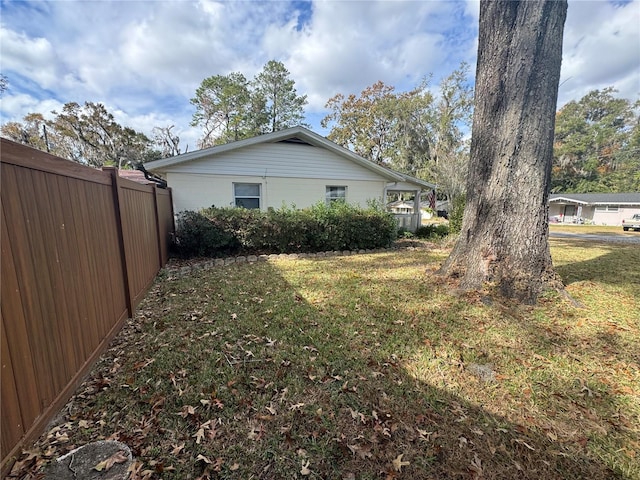 view of side of property with a lawn