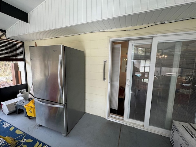 kitchen with stainless steel fridge and beam ceiling