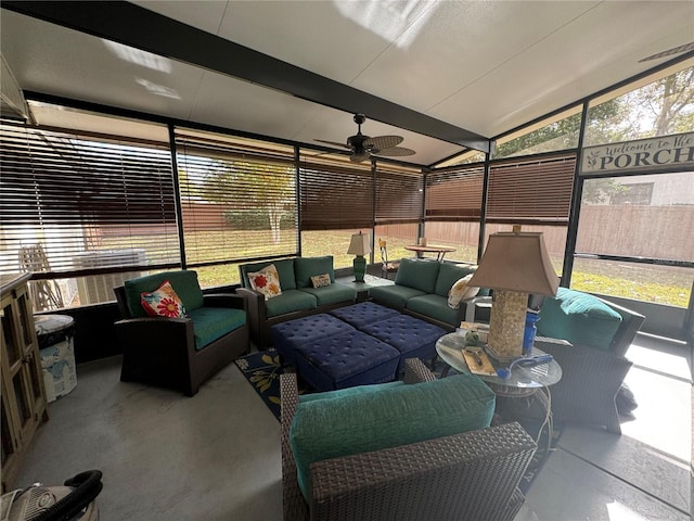 sunroom / solarium with ceiling fan and lofted ceiling with beams