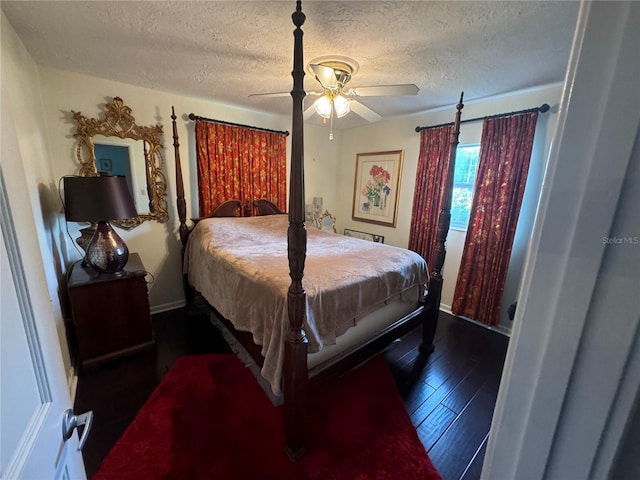 bedroom featuring ceiling fan, dark hardwood / wood-style flooring, and a textured ceiling