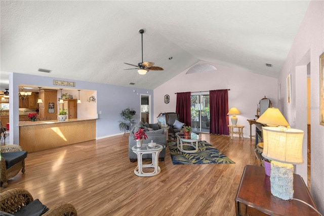 living room with ceiling fan, hardwood / wood-style floors, and lofted ceiling