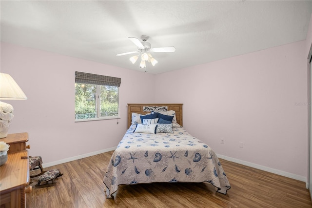 bedroom with ceiling fan and wood-type flooring