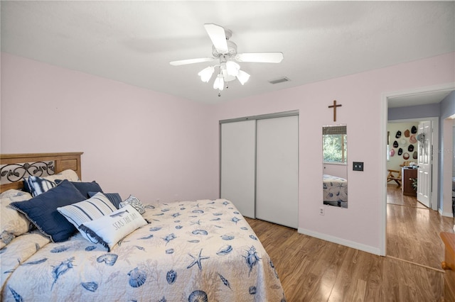 bedroom featuring ceiling fan, a closet, and light hardwood / wood-style flooring