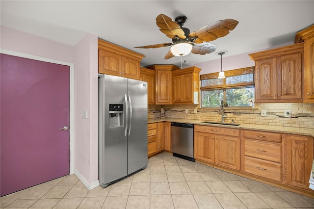 kitchen featuring light stone countertops, sink, ceiling fan, tasteful backsplash, and appliances with stainless steel finishes