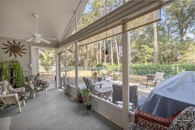 sunroom / solarium featuring plenty of natural light, ceiling fan, and lofted ceiling