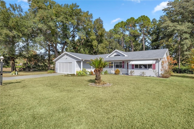 ranch-style house featuring covered porch, a front yard, and a garage