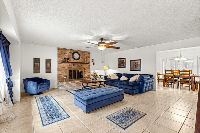 living room featuring a fireplace, a textured ceiling, ceiling fan with notable chandelier, and light tile patterned floors