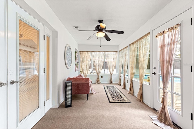 sunroom / solarium featuring ceiling fan