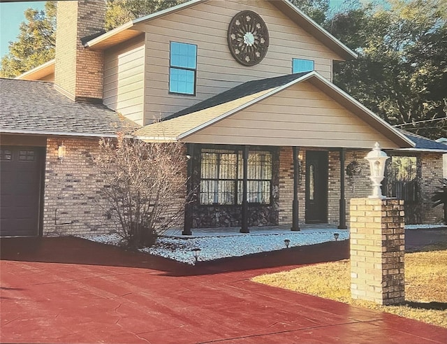 exterior space with a porch and a garage