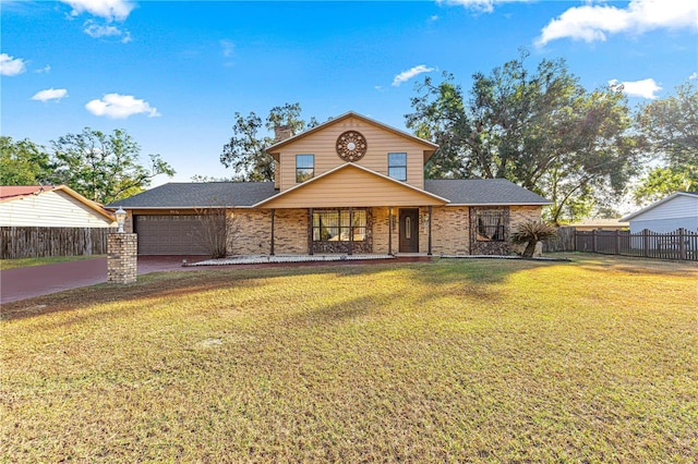 view of property featuring a garage and a front yard