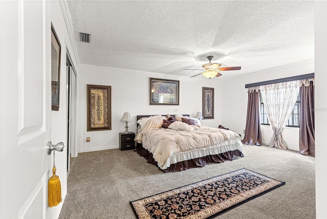 bedroom featuring ceiling fan, crown molding, carpet, and a textured ceiling