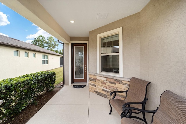 property entrance featuring a patio