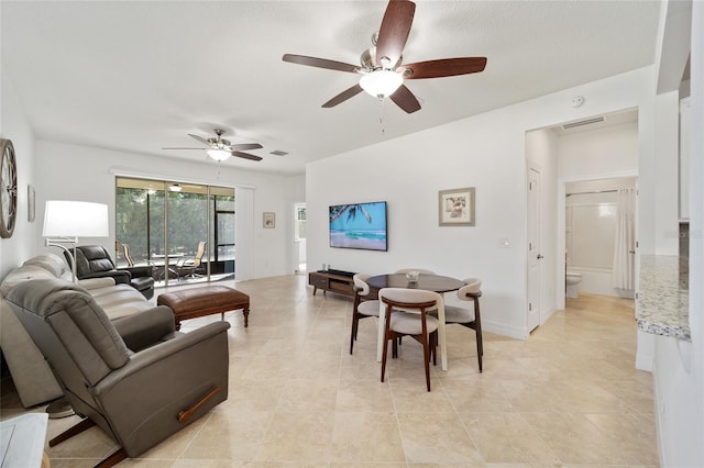 living room featuring ceiling fan and light tile patterned floors